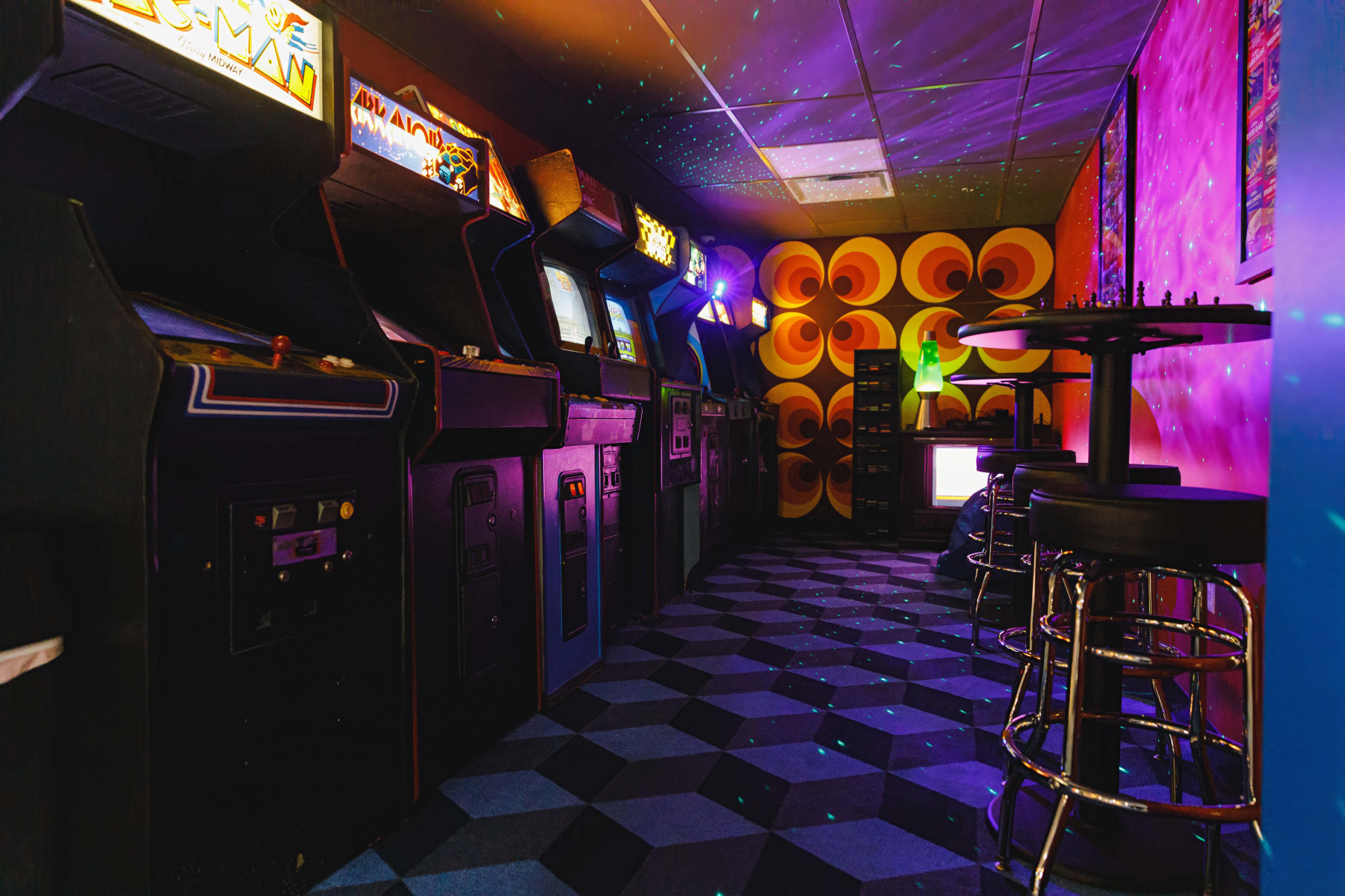 Inside YESTERcades arcade with glowing machines